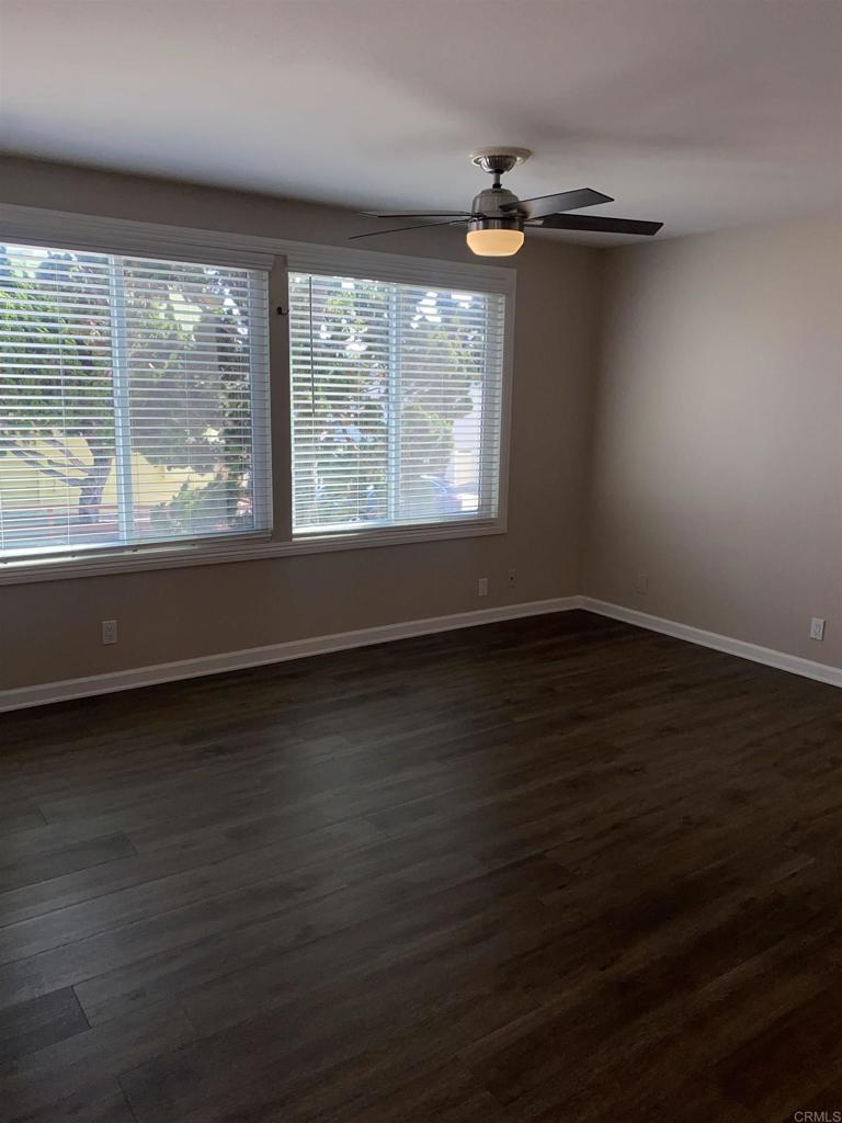 2088 Montgomery Avenue, Unit M Cardiff-by-the-Sea, CA 92007 - Photo 9 of 43 an empty room with wooden floor and windows