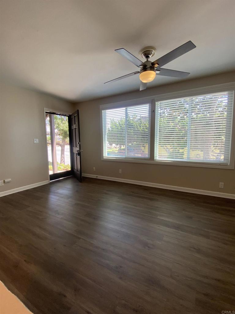 2088 Montgomery Avenue, Unit M Cardiff-by-the-Sea, CA 92007 - Photo 10 of 43 an empty room with wooden floor and windows