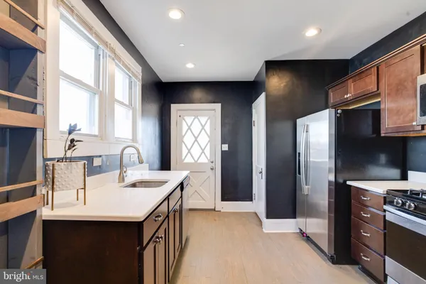 a bathroom with a double vanity sink and a window