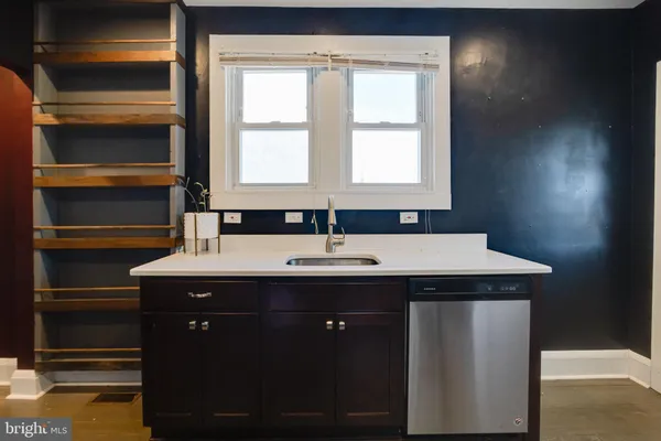 a kitchen with stainless steel appliances granite countertop a sink a stove a refrigerator and a microwave