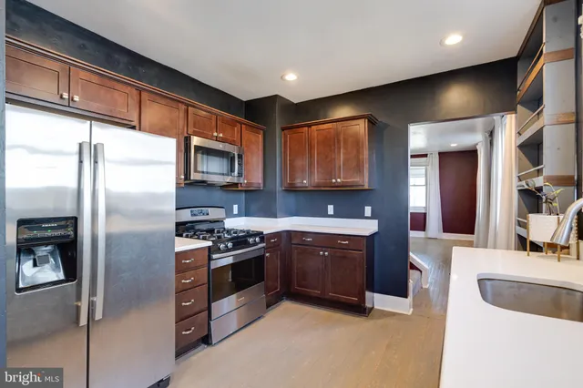a view of a livingroom with wooden floor and a flat screen tv
