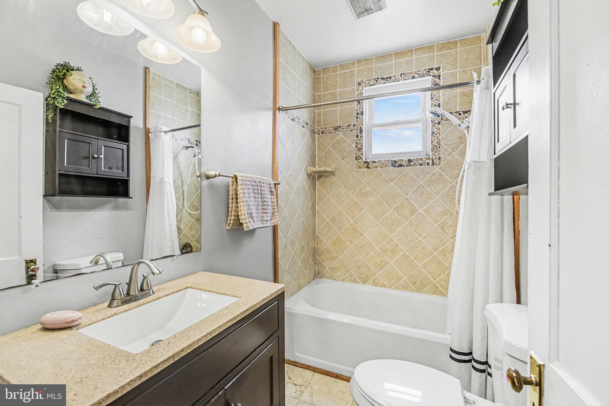 2513 Wagner Avenue Sparrows Point, MD 21219 - Photo 17 of 28 a bathroom with a granite countertop sink toilet and shower