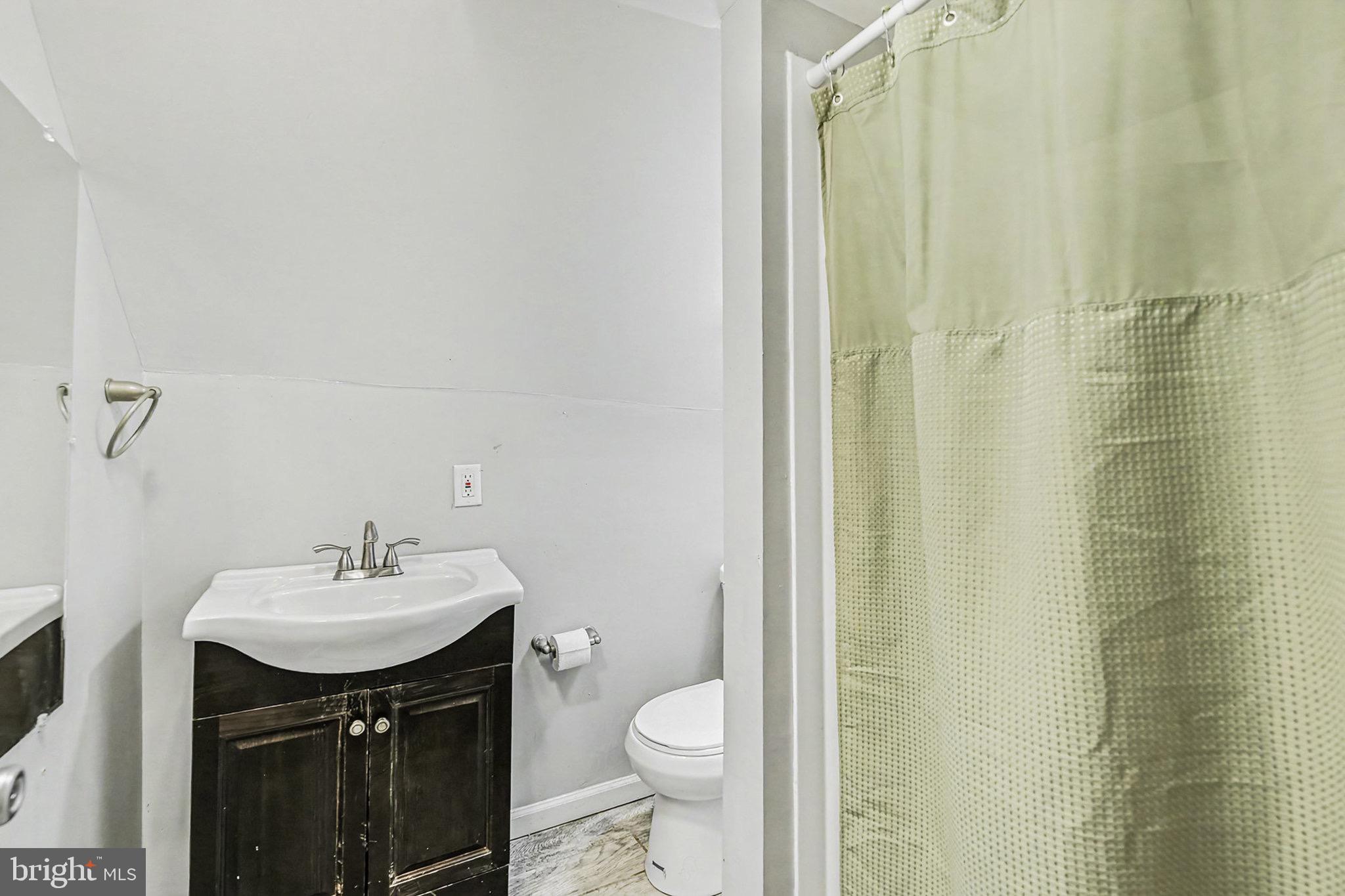 2513 Wagner Avenue Sparrows Point, MD 21219 - Photo 20 of 28 a bathroom with a sink a toilet and shower