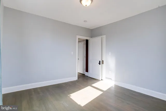 an empty room with windows and closet