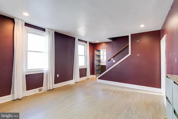 an empty room with windows and closet
