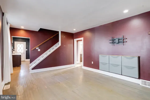 an empty room with closet and windows