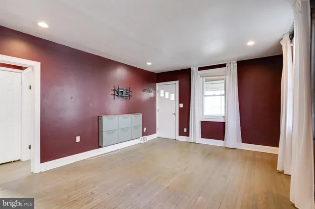 an empty room with windows and closet