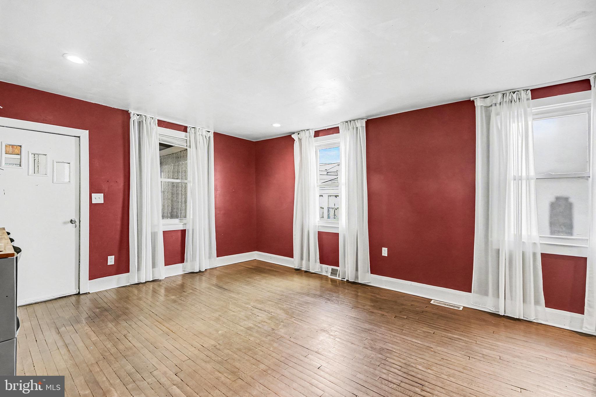 2513 Wagner Avenue Sparrows Point, MD 21219 - Photo 9 of 28 an empty room with wooden floor and windows