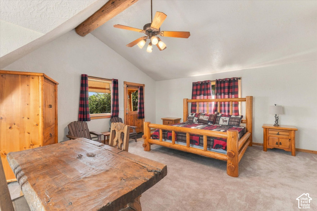 1701 Oak Road Coalville, UT 84017 - Photo 59 of 71 Vaulted ceiling with exposed wood beams, a ceiling fan with integrated lighting, wood-finish flooring, and a solid wood door