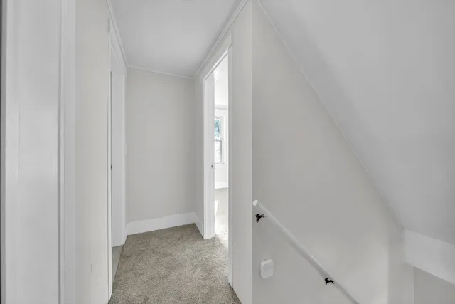 a view of a hallway view with wooden floor and front door
