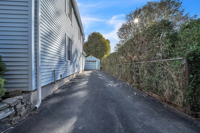 an aerial view of a house with a yard and large tree