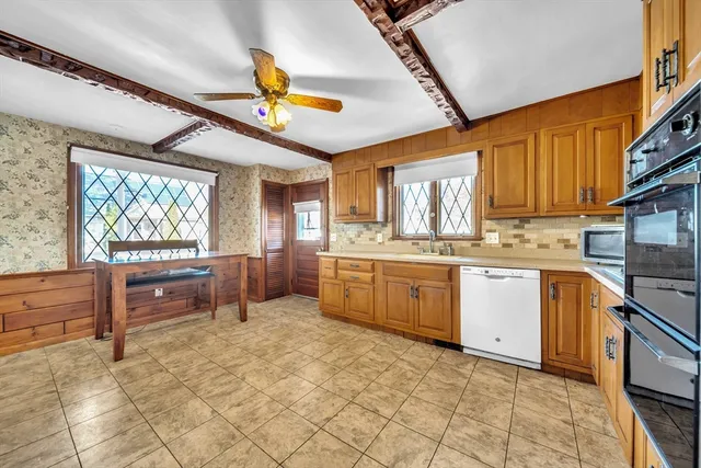 a kitchen with a stove a sink and a refrigerator