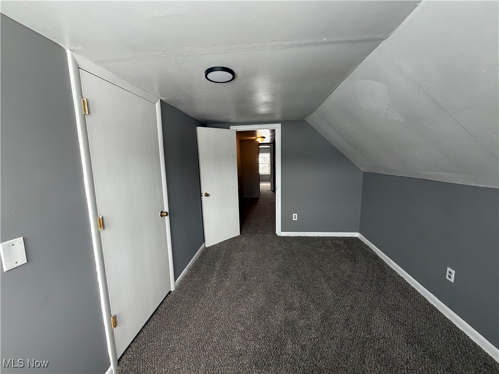 16309 Nela View Road Cleveland, OH 44112 - Photo 20 of 29 Additional living space with dark carpet and vaulted ceiling
