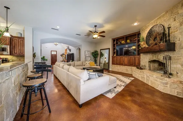 a living room with furniture and a fireplace