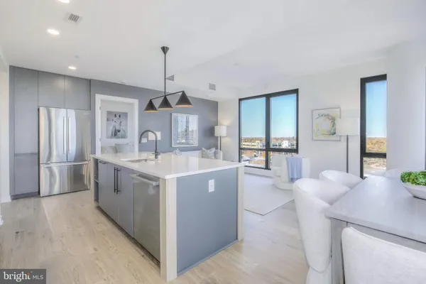 a kitchen with stainless steel appliances granite countertop a sink and a refrigerator