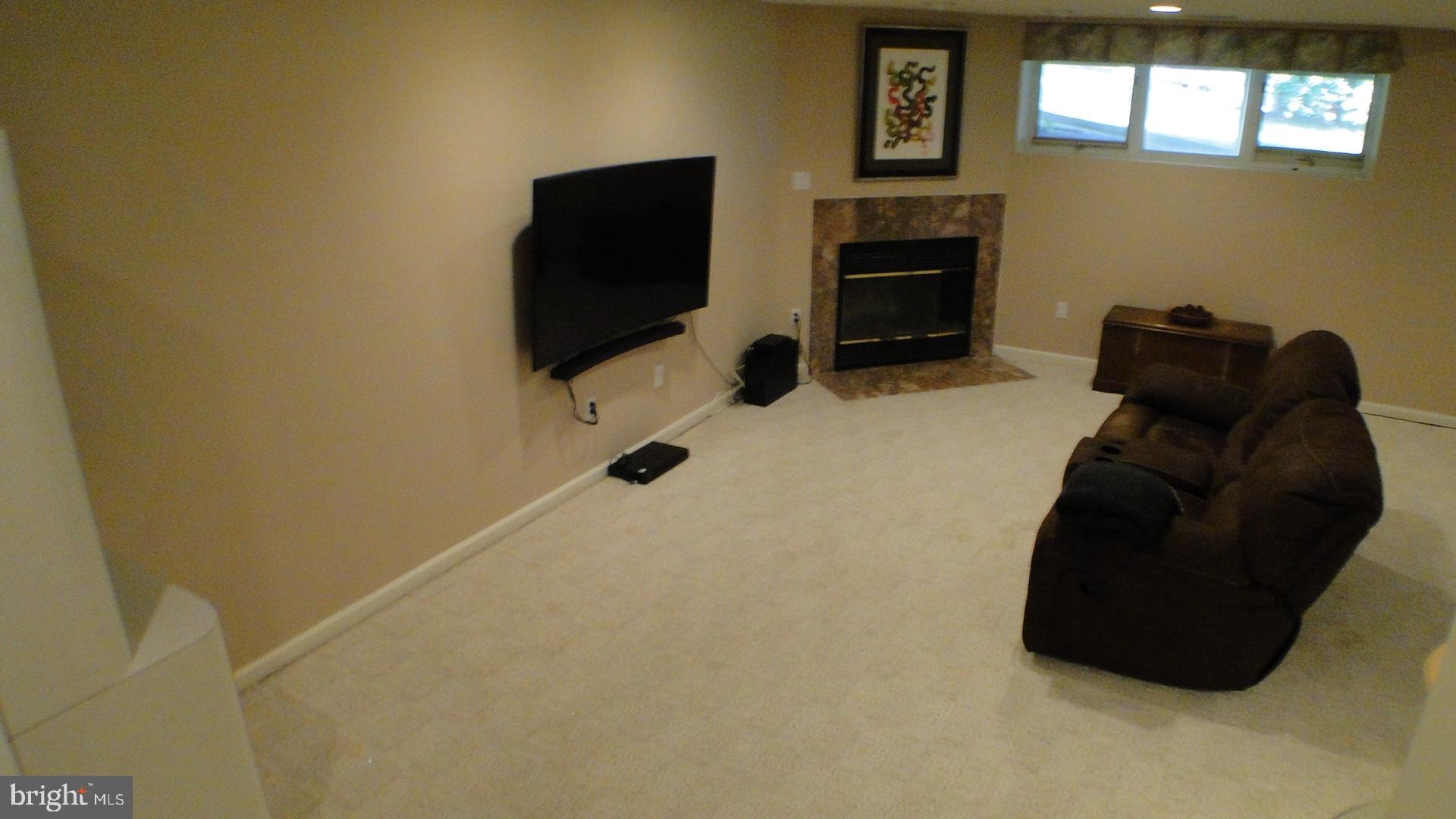 5175 Columbia Road, Unit 1143 Columbia, MD 21044 - Photo 31 of 48 Basement Recreation Room with wood burning FP.