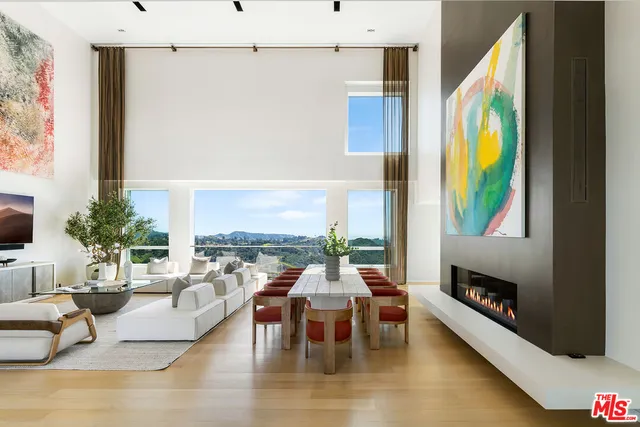 a kitchen with kitchen island a stove a table and chairs in it