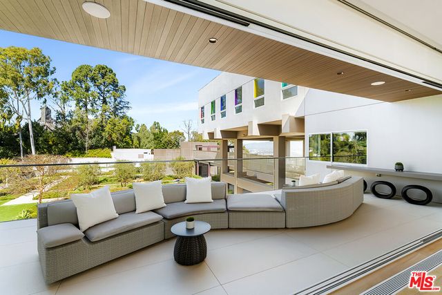 a view of a dining room with furniture large windows and wooden floor