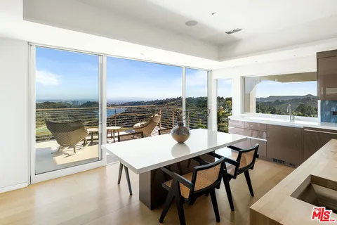 a living room with furniture fireplace and a large window
