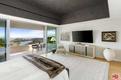 a bedroom with a bed and a couch