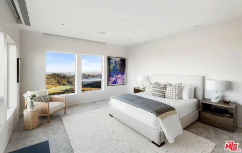 a living room with furniture and large windows