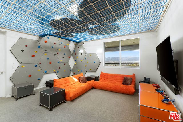 a living room with a large window and a fireplace