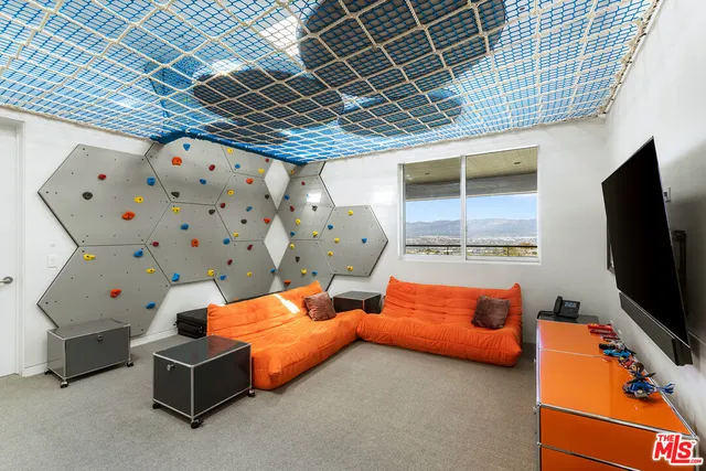 a living room with a large window and a fireplace