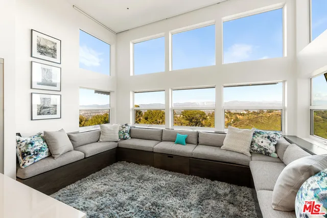 a view of a swimming pool with chairs in patio