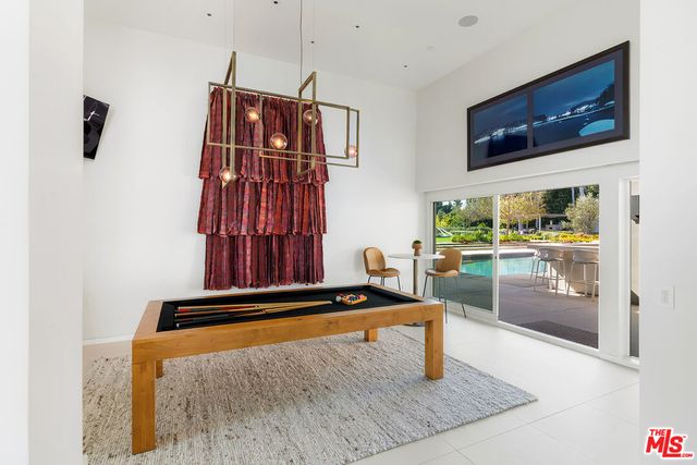 a view of a swimming pool with a bench and trees
