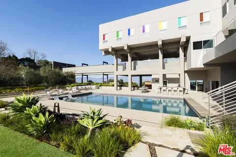 a view of swimming pool with outdoor seating and city view