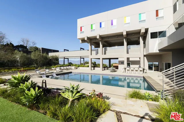 a view of swimming pool with outdoor seating and city view