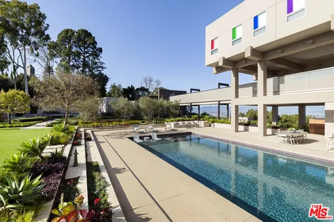 a view of a swimming pool with outdoor seating