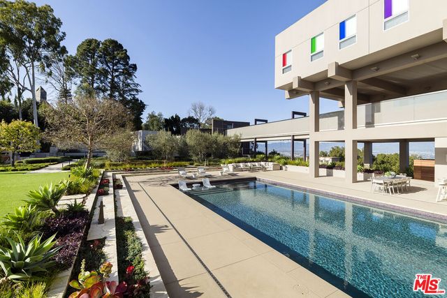 a view of a swimming pool with outdoor seating