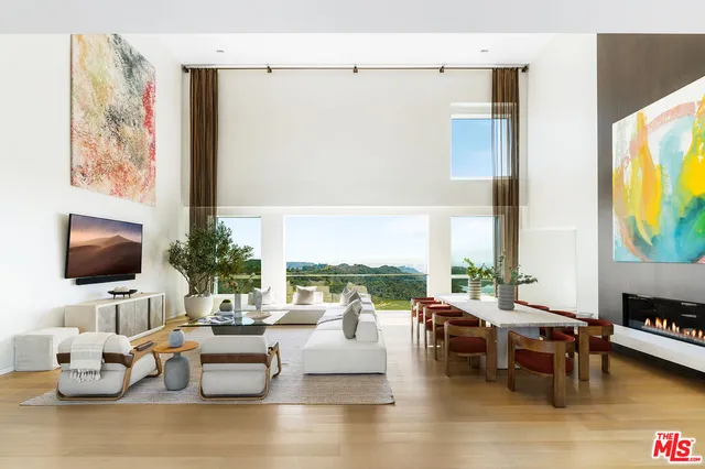 a room with patio furniture and a large window