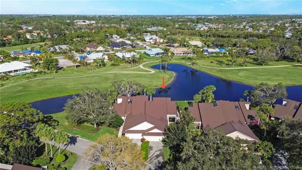 5011 Southeast Brandywine Way Stuart, FL 34997 - Photo 17 of 19 an aerial view of a house with a garden and lake view