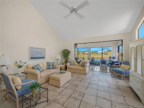 a living room with furniture and a floor to ceiling window