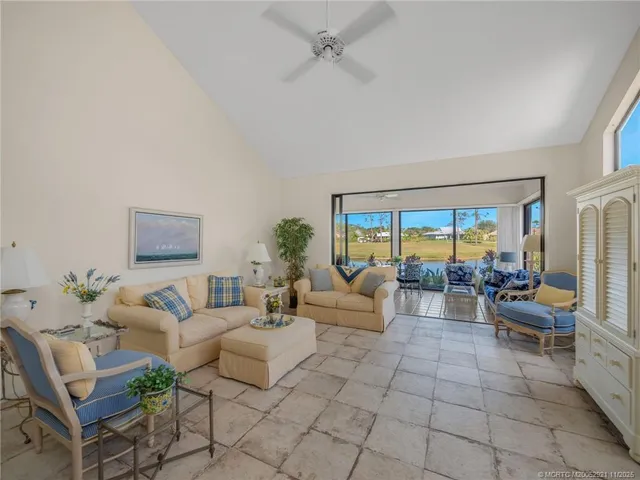 a living room with furniture and a floor to ceiling window