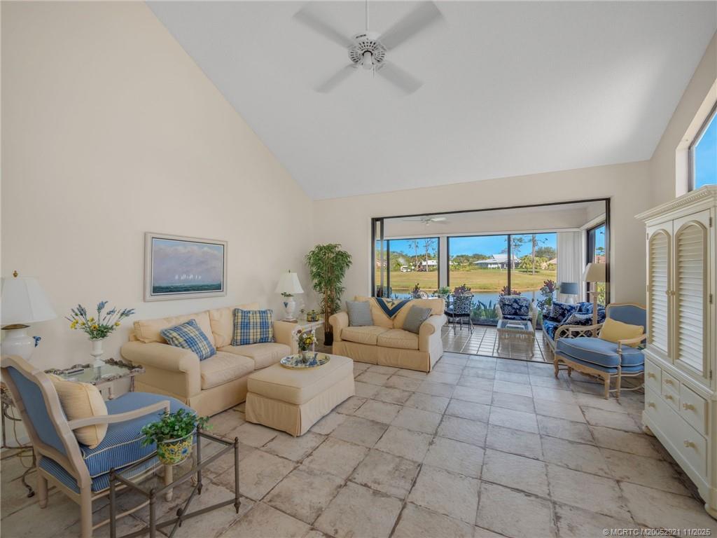 5011 Southeast Brandywine Way Stuart, FL 34997 - Photo 5 of 19 a living room with furniture and a floor to ceiling window