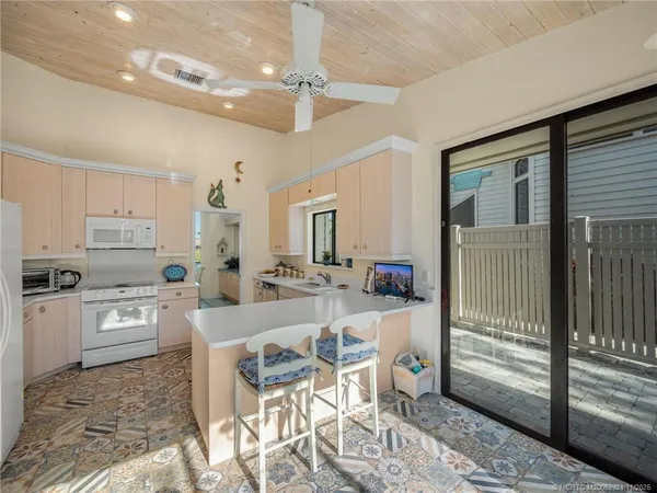 a kitchen with microwave a stove and refrigerator