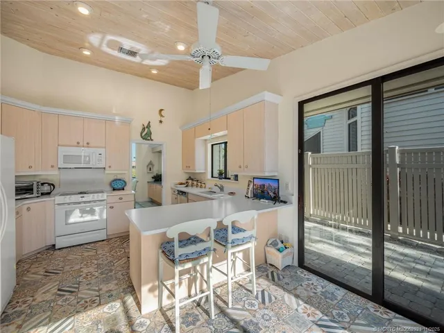 a kitchen with microwave a stove and refrigerator