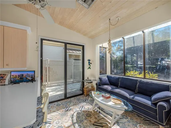 a living room with furniture and a floor to ceiling window
