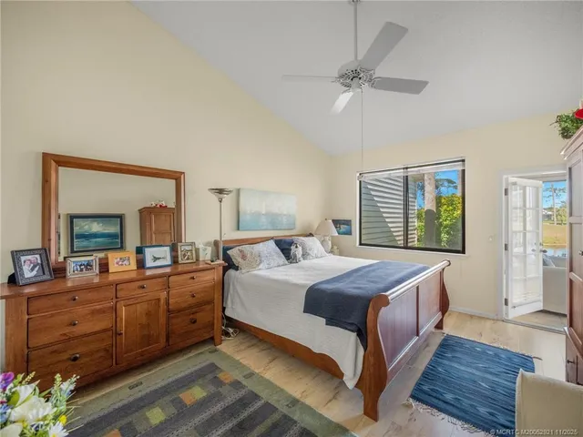 a bedroom with a large bed and a chandelier