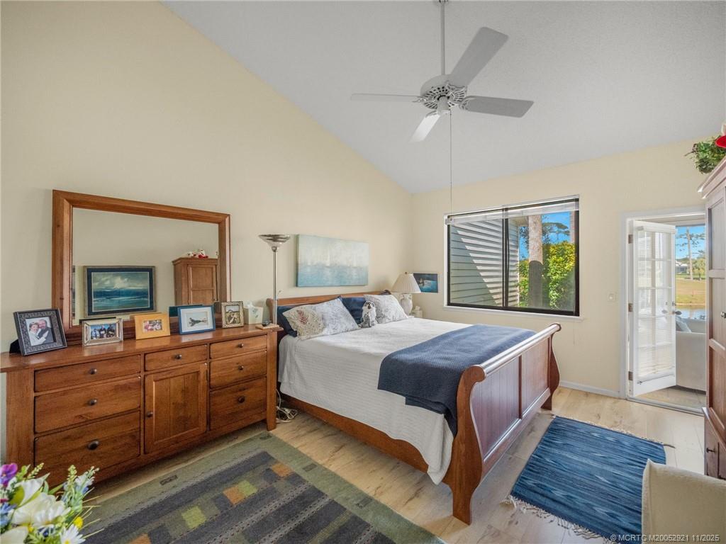 5011 Southeast Brandywine Way Stuart, FL 34997 - Photo 10 of 19 a bedroom with a large bed and a chandelier