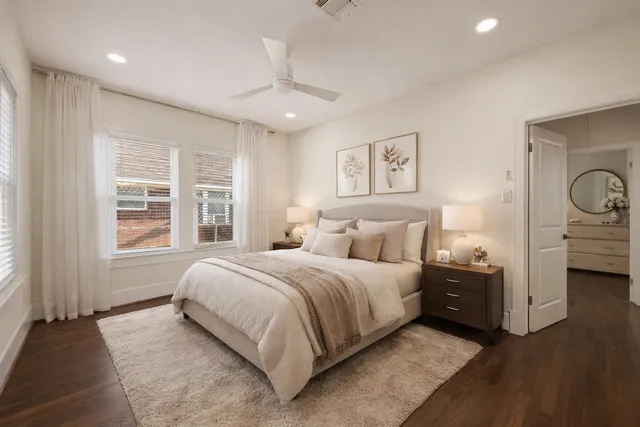 a view of a livingroom with wooden floor and a large window