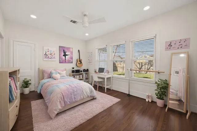 a view of empty room with wooden floor and window
