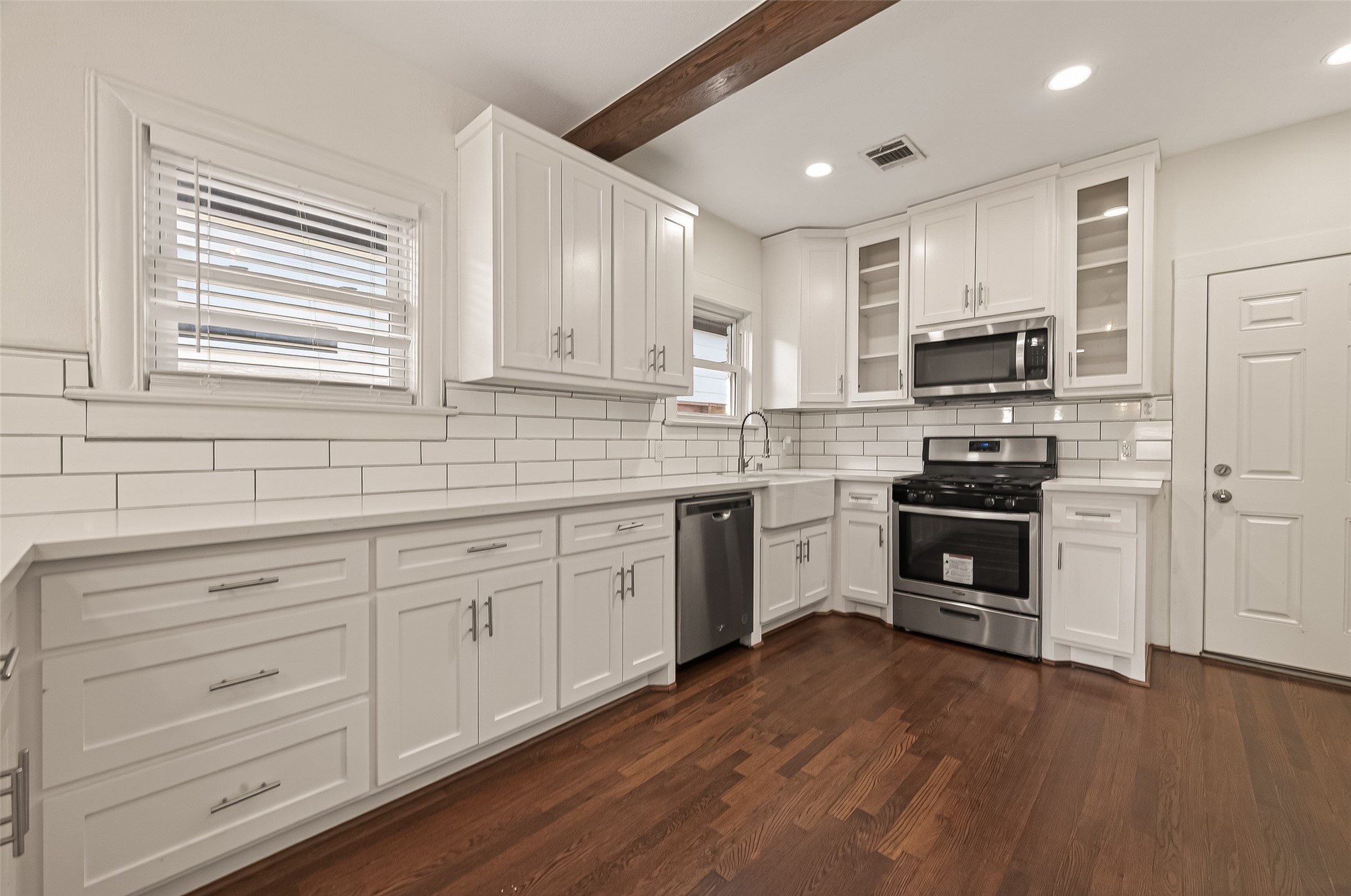2417 Ruth Street Houston, TX 77004 - Photo 10 of 33 a kitchen with granite countertop white cabinets and white appliances