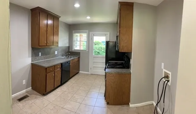 a kitchen with a refrigerator and a sink