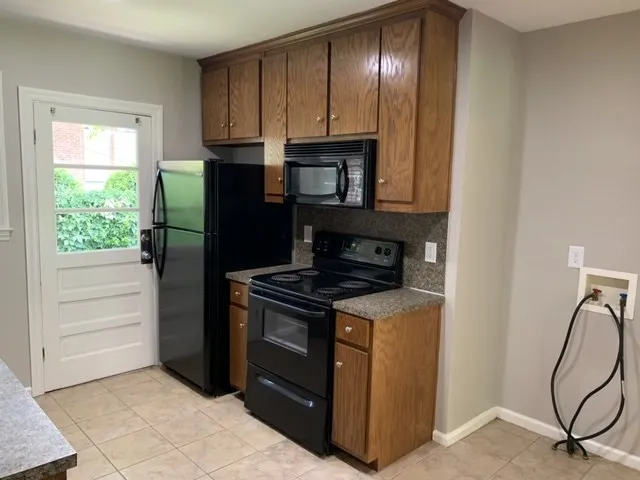 a kitchen with granite countertop cabinets and steel stainless steel appliances