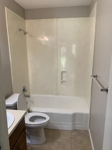 a bathroom with a bathtub and a toilet