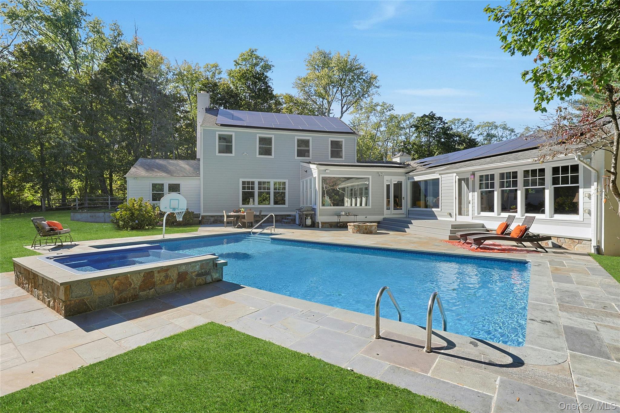 8 Creemer Road Armonk, NY 10504 - Photo 2 of 38 a view of a house with swimming pool and sitting area
